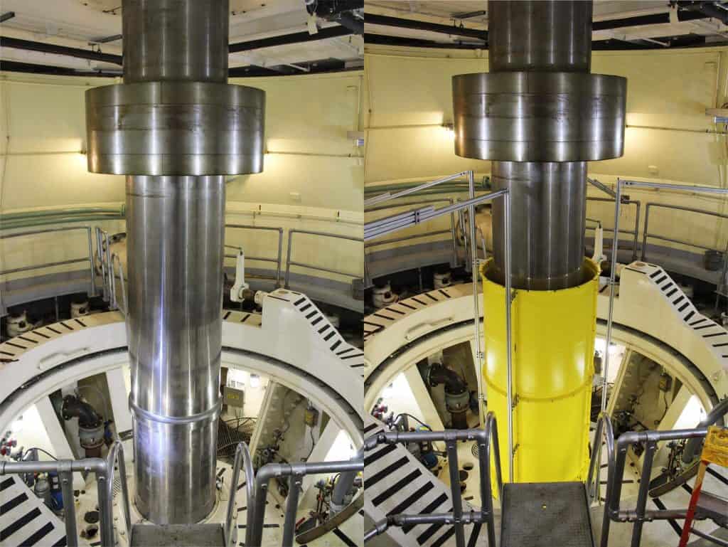 High-strength turbine shaft guard protecting equipment at hydroelectric facility.