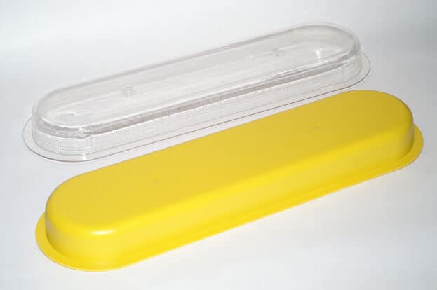 Yellow protective cover for safety equipment with clear lid.
