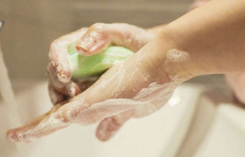 Hände beim gründlichen Waschen mit Seife, ein wichtiger Bestandteil des Hygieneplans in der Zahnarztpraxis.