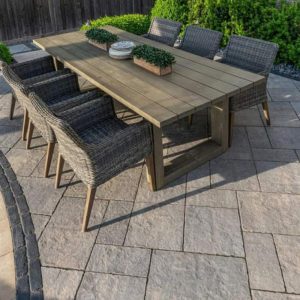 Outdoor dining table with wicker chairs for garden or patio use.