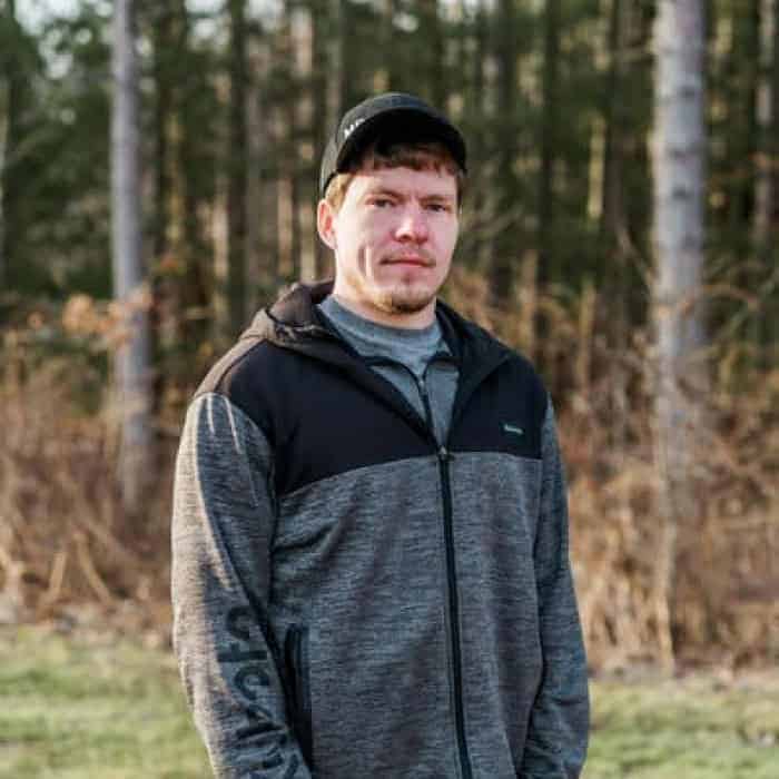 Man standing outdoors in casual wear for website About Us section.