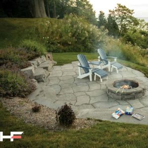 Outdoor fire pit with two Adirondack chairs and cozy setup.