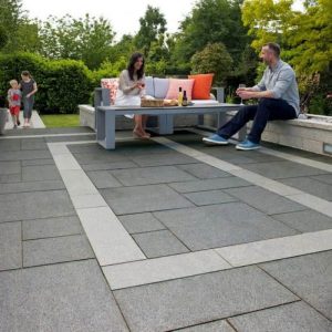 Outdoor patio with modern seating and family enjoying a sunny day.