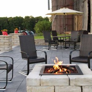 Outdoor patio with fire pit and seating area for relaxing and entertaining.