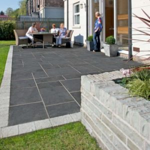 Modern outdoor patio with seating area and landscaping.