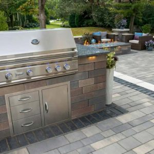 Outdoor kitchen with grill and seating for outdoor dining and entertaining.