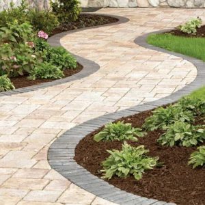 Elegant winding brick pathway in a landscaped garden setting.