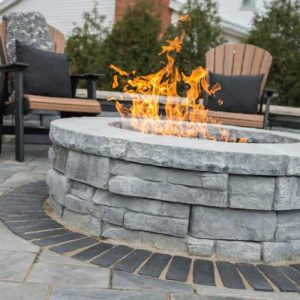 Fire pit with stone surround for outdoor living and entertaining.