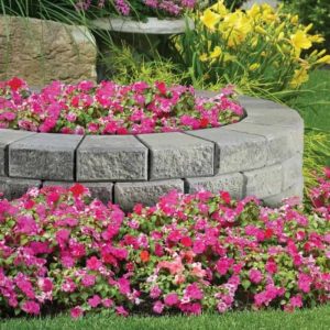 Beautiful garden featuring stackstone borders and colorful blooming flowers.