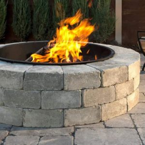 Fire pit with bright flames in a cozy outdoor space.