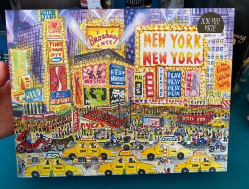 Colorful Times Square New York City puzzle with taxis and billboards.