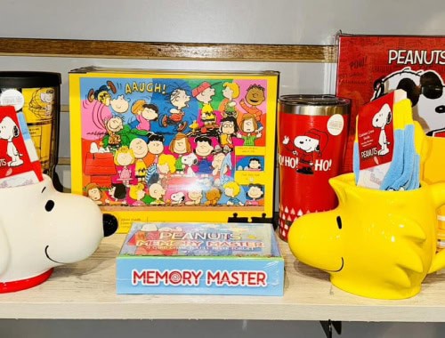 Peanuts Snoopy themed toys and accessories on store shelf.
