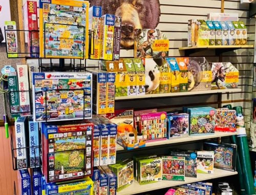 assortment of puzzles and 3d puzzles