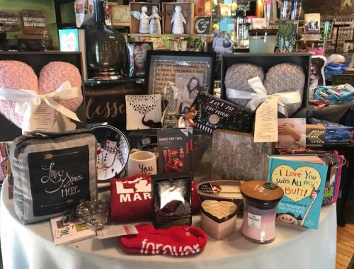 Assorted gift items including candles, mugs, and framed art on display at Molehole Marshall.