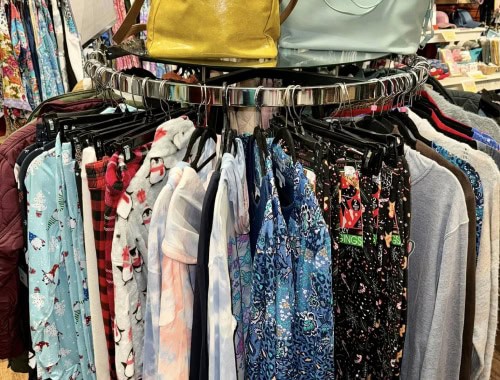 Assorted pajama pants hanging on a circular rack in a retail store.