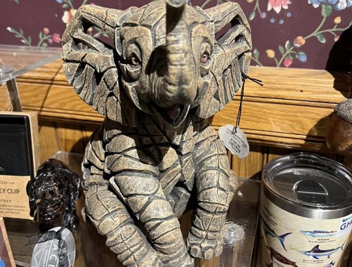 Detailed stone elephant sculpture with textured surface and realistic features.