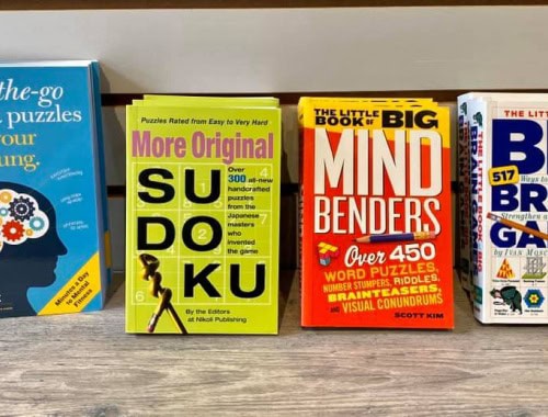Collection of puzzle books including Sudoku, Mind Benders, and Brain Games.