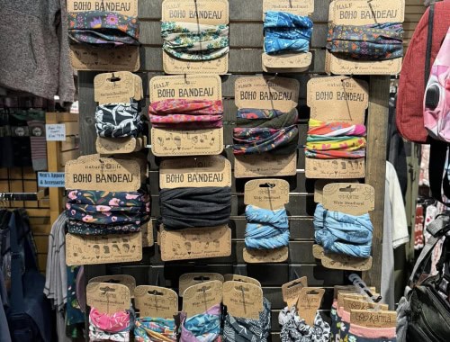 Colorful boho bandeau headbands arranged on a display rack.