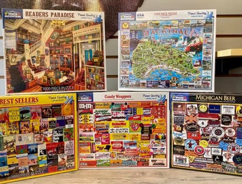 Collection of five 1000-piece puzzles with different themes and artwork.