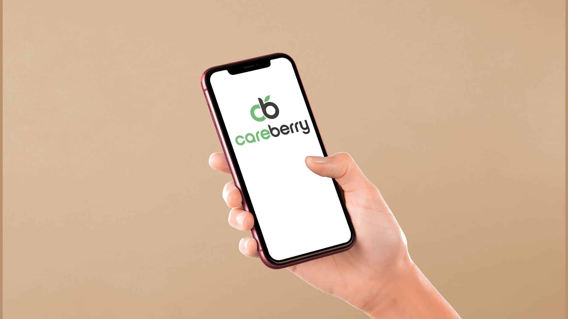 A hand holds a smartphone displaying the Careberry logo on the screen. The logo consists of a stylized lowercase "cb" with a leaf over the "b," and the text "careberry" below it. The phone has a dark-colored frame against a beige background.