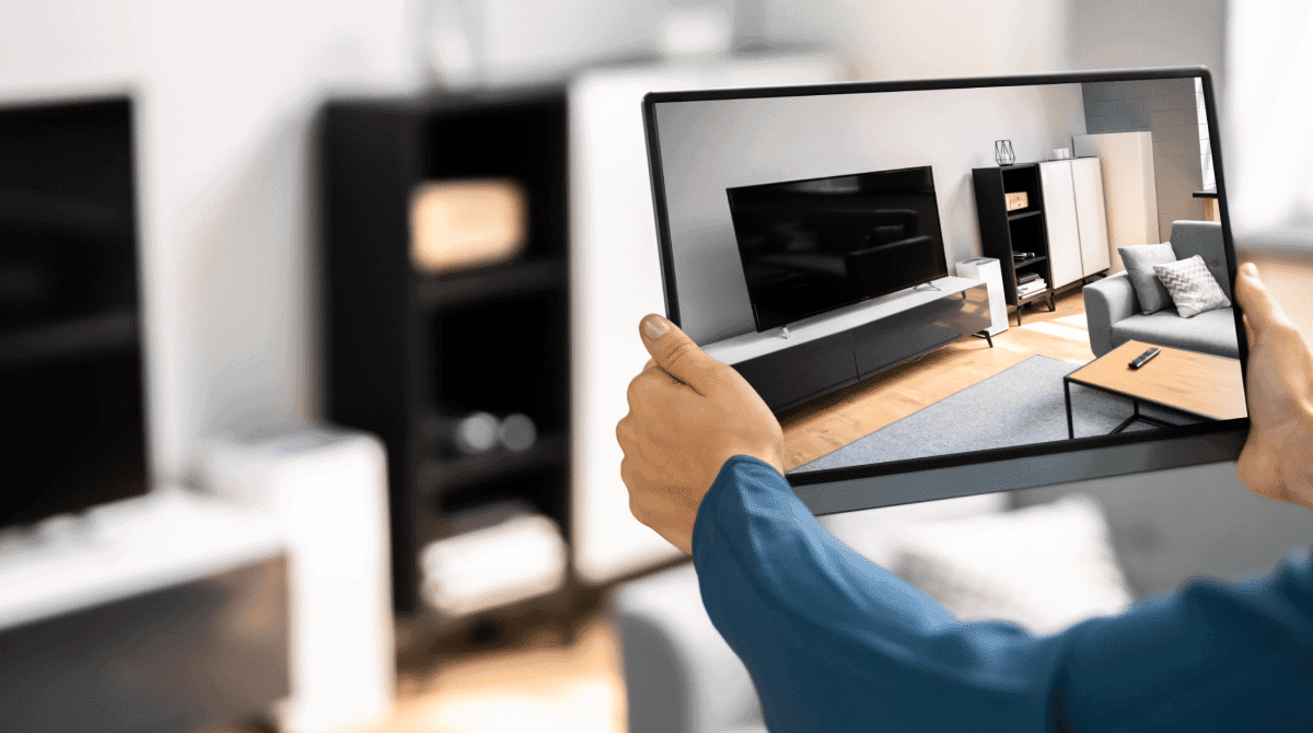 Person viewing 3D interior design of a living room on a tablet device.