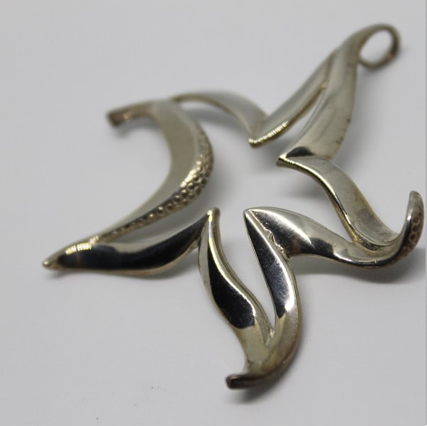 Un pendentif en forme d'étoile de mer évoque l'élégance des profondeurs marines, idéal pour les passionnés de plongée.
