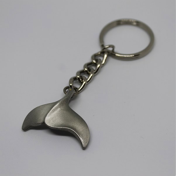Porte-clés en forme de queue de baleine, symbole élégant de l'aventure océanique et de la passion pour la plongée.