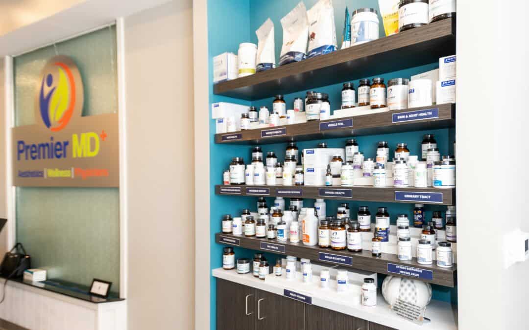 Display shelf with various supplement bottles at PremierMD+ clinic.