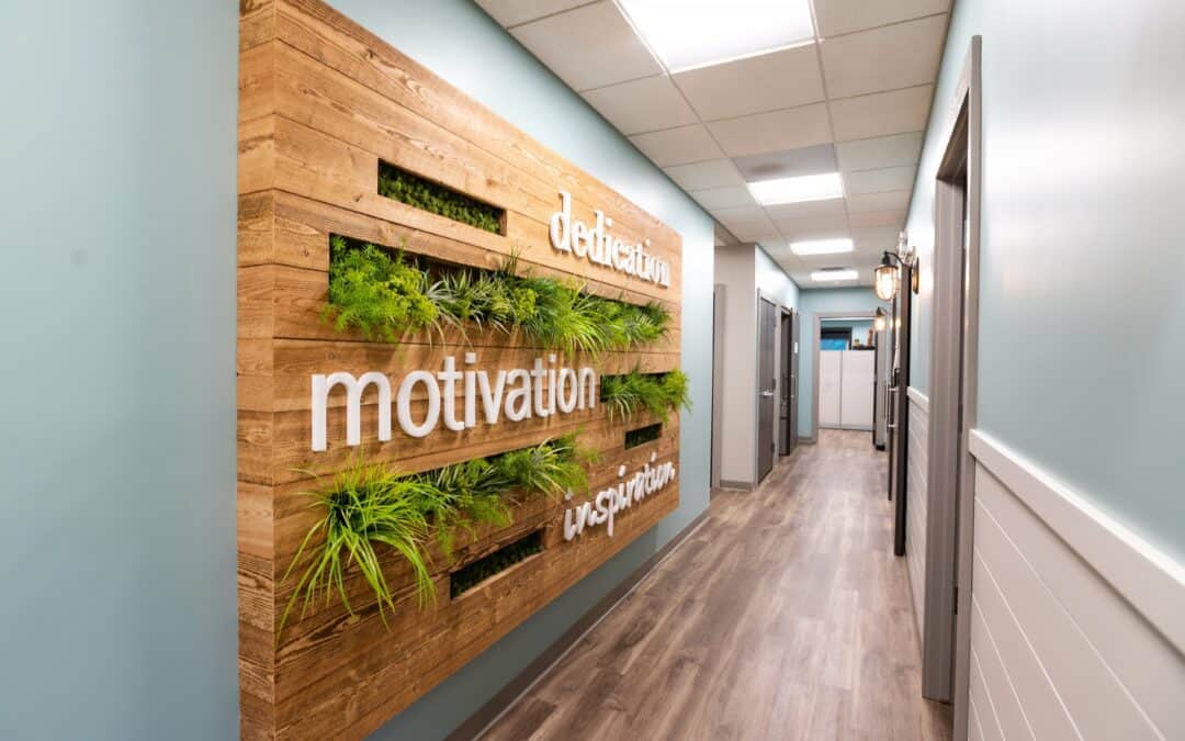Modern office hallway with motivational wall decor and wooden accents.