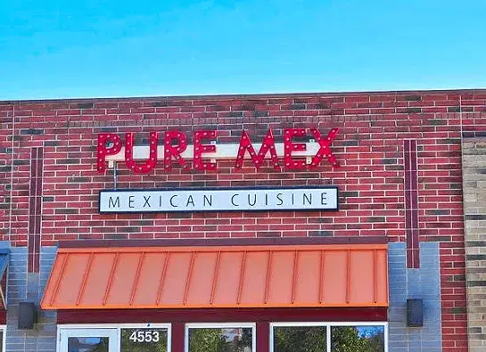 Front entrance of Pure Mex Grandville with red signage—your destination for tacos, tequila, and Mexican food near Grand Rapids.