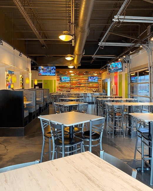 Modern bar and dining space with festive decor—welcoming atmosphere at all Pure Mex Tacos & Tequila locations.