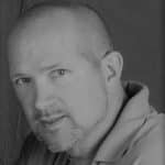 Black and white portrait of a man with a beard and short hair.
