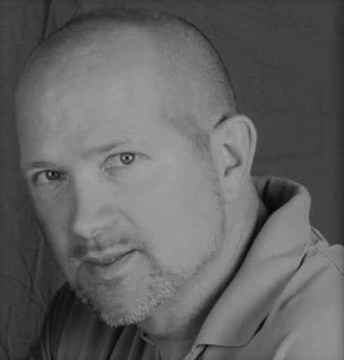 Black and white portrait of a man with a beard and short hair.