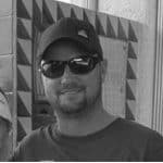 Man wearing sunglasses and cap smiling at Reality Capture Experts.