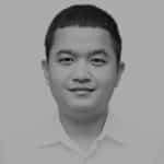 Black and white portrait of a young man with short hair and a collared shirt.