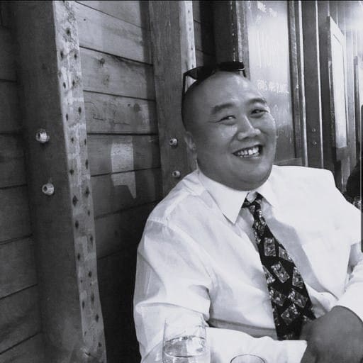 Smiling man in white shirt and tie at Reality Capture Experts.