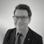 Portrait of Bojan V. in professional attire with glasses.