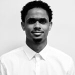 Black and white portrait of a man in a white shirt.