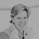 Smiling woman with short hair in a professional setting.