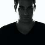 Black and white portrait of a man with intense expression.