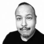 Black and white portrait of a man with a mustache and short hair.