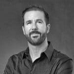 Black and white portrait of Hajo R. with a beard and short hair.
