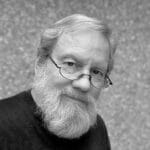 Black and white photo of Harlan H. with glasses and beard.