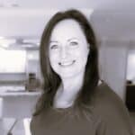 Portrait of Jann N. smiling in an office setting.