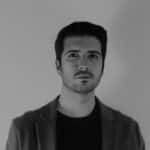 Portrait of Juan M. in black and white, professional headshot.