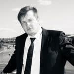 Portrait of a man in a suit outdoors, black and white image.