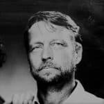 Black and white portrait of a man with beard and mustache.