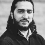 Black and white portrait of a man with long hair and beard.