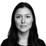 Portrait of a woman with long dark hair, neutral expression, black and white photo.