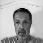 Black and white photo of a middle-aged man with short hair and beard.